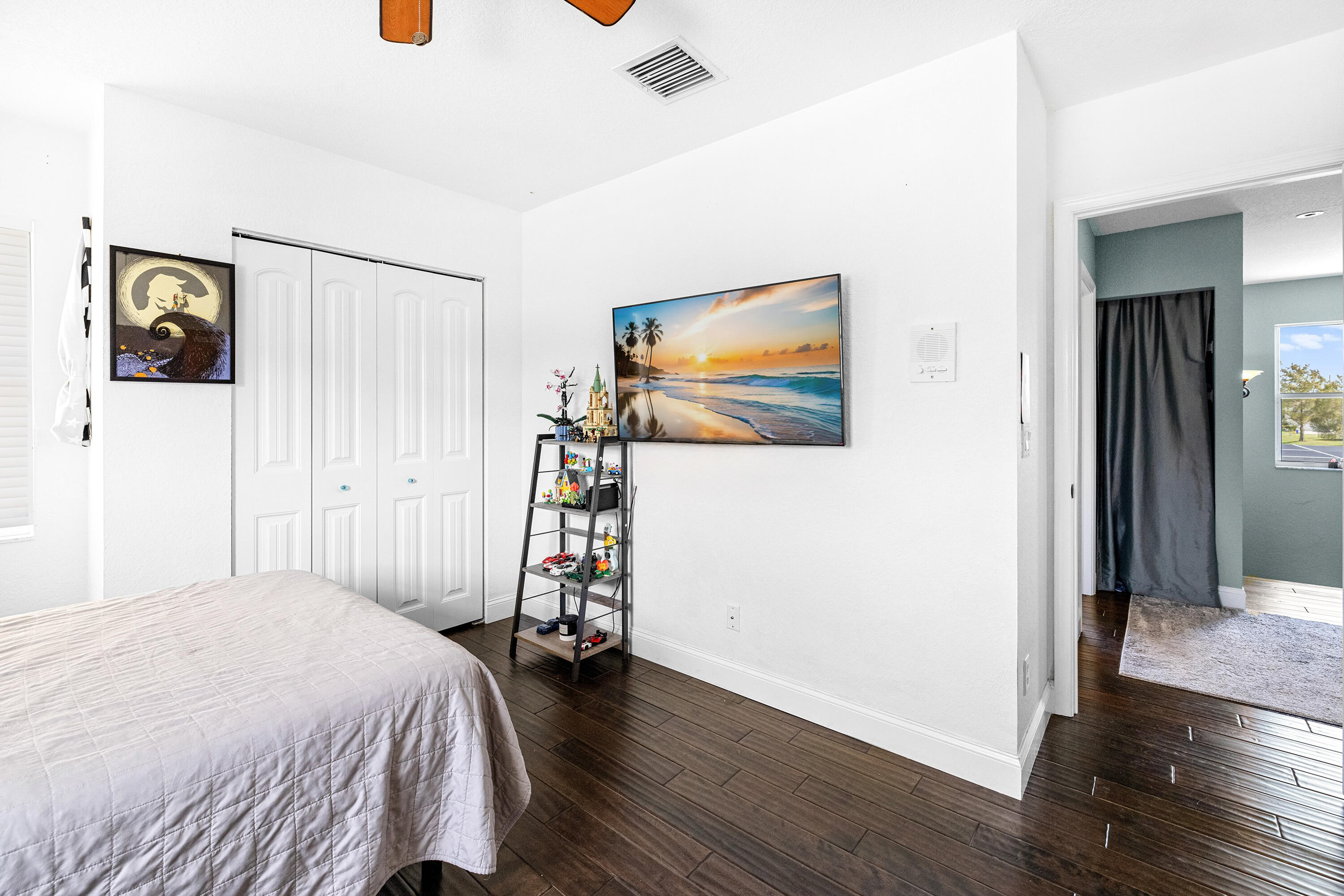 6575 Spring Meadow Drive Greenacres, FL 33413 - Photo 30 of 54 a bedroom with a bed and a flat screen tv