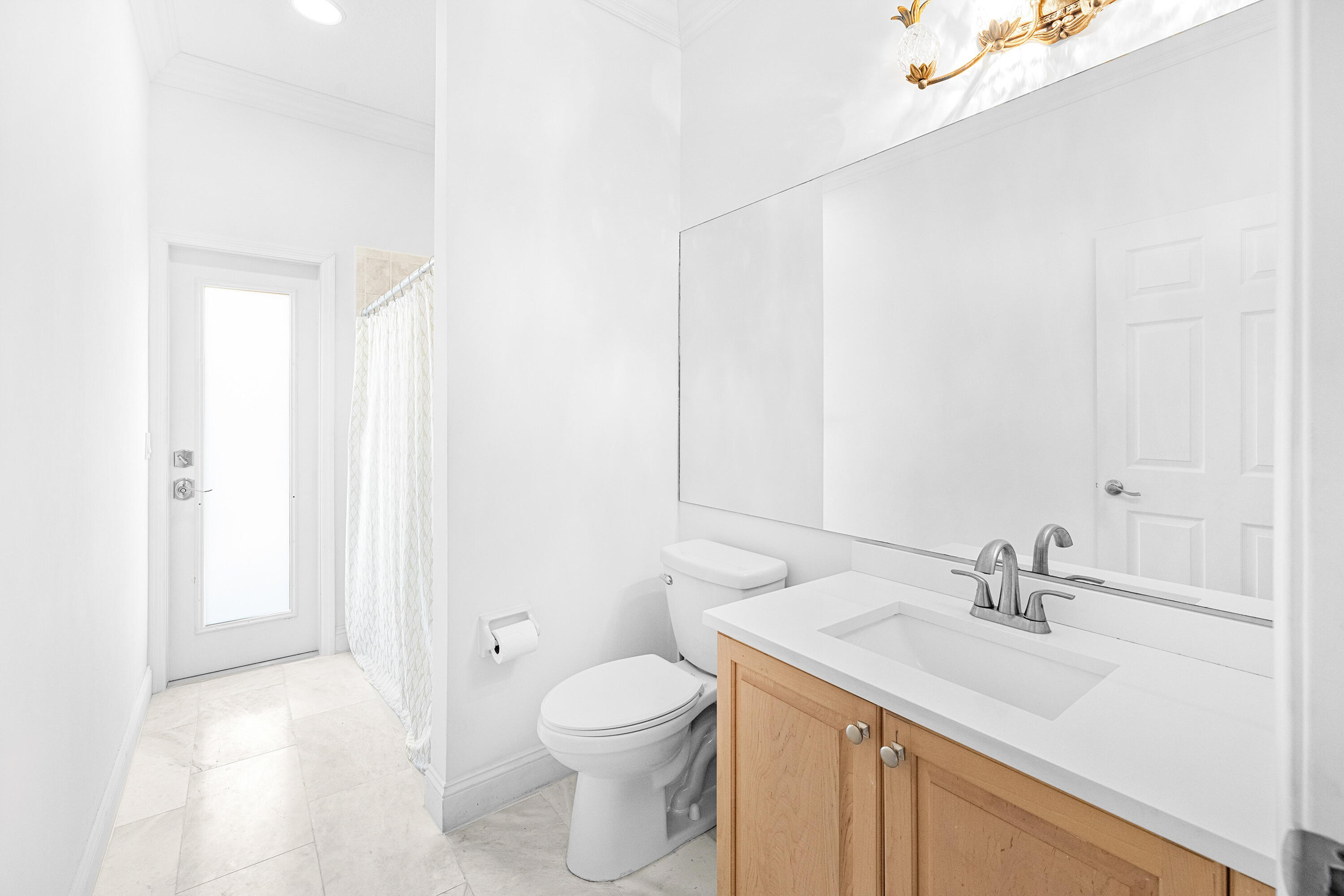 6575 Spring Meadow Drive Greenacres, FL 33413 - Photo 31 of 54 a bathroom with a sink a toilet and a mirror