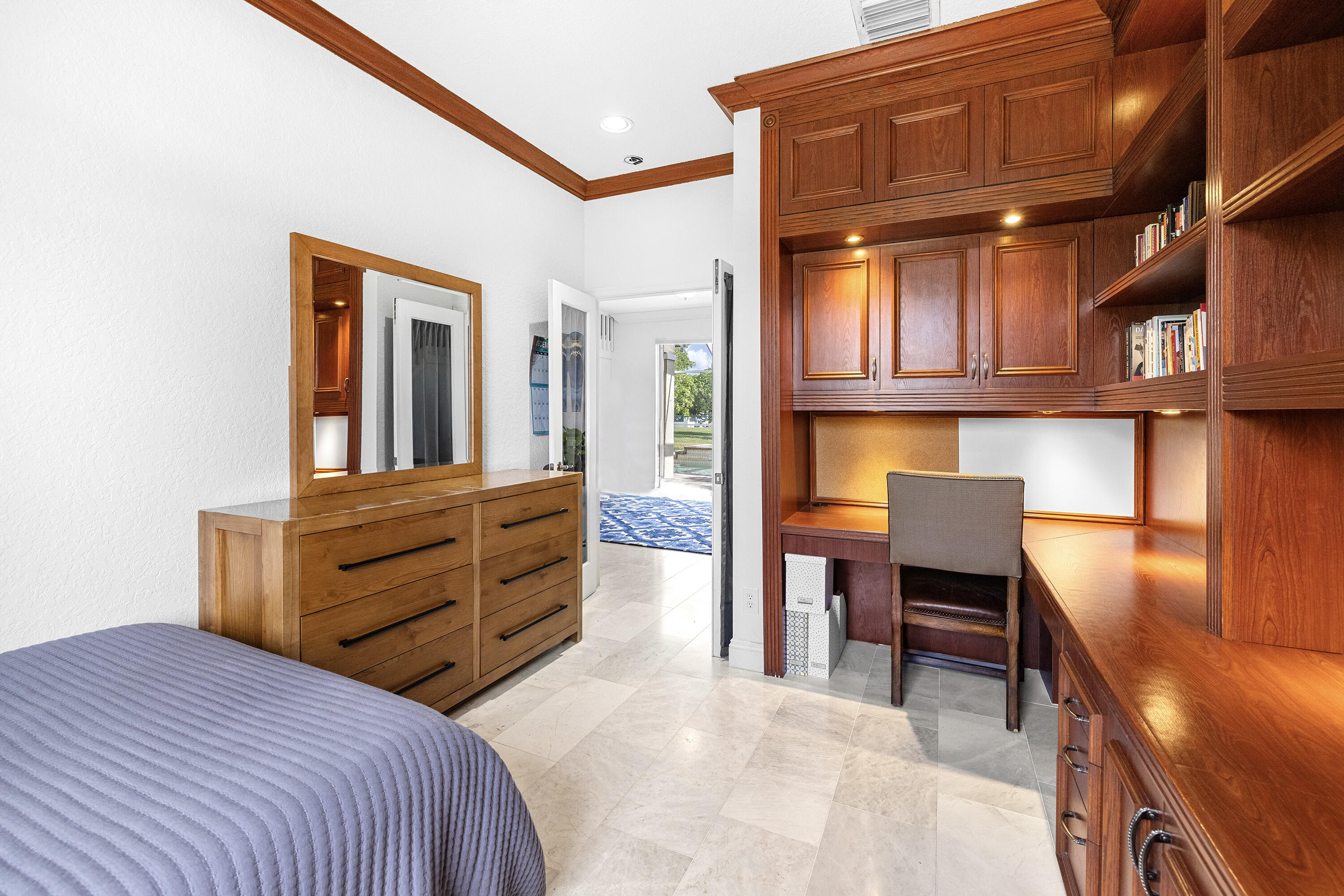 6575 Spring Meadow Drive Greenacres, FL 33413 - Photo 33 of 54 a bedroom with a bed and furniture