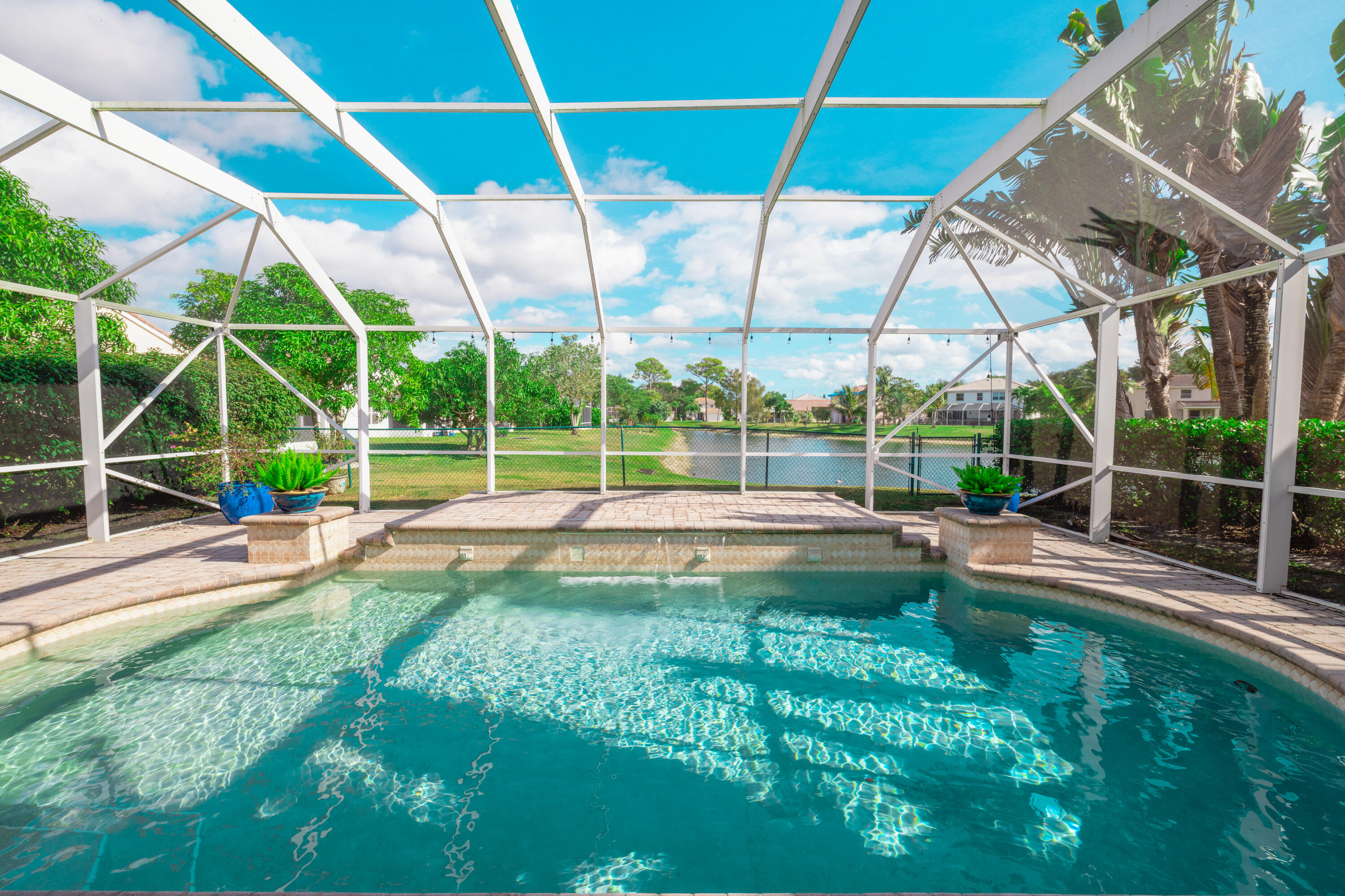 6575 Spring Meadow Drive Greenacres, FL 33413 - Photo 37 of 54 a view of a backyard with a swimming pool
