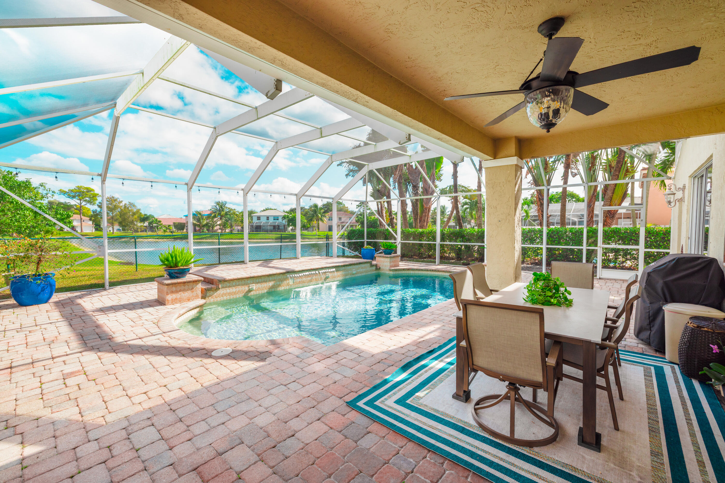 6575 Spring Meadow Drive Greenacres, FL 33413 - Photo 38 of 54 a view of a patio with a table and chairs