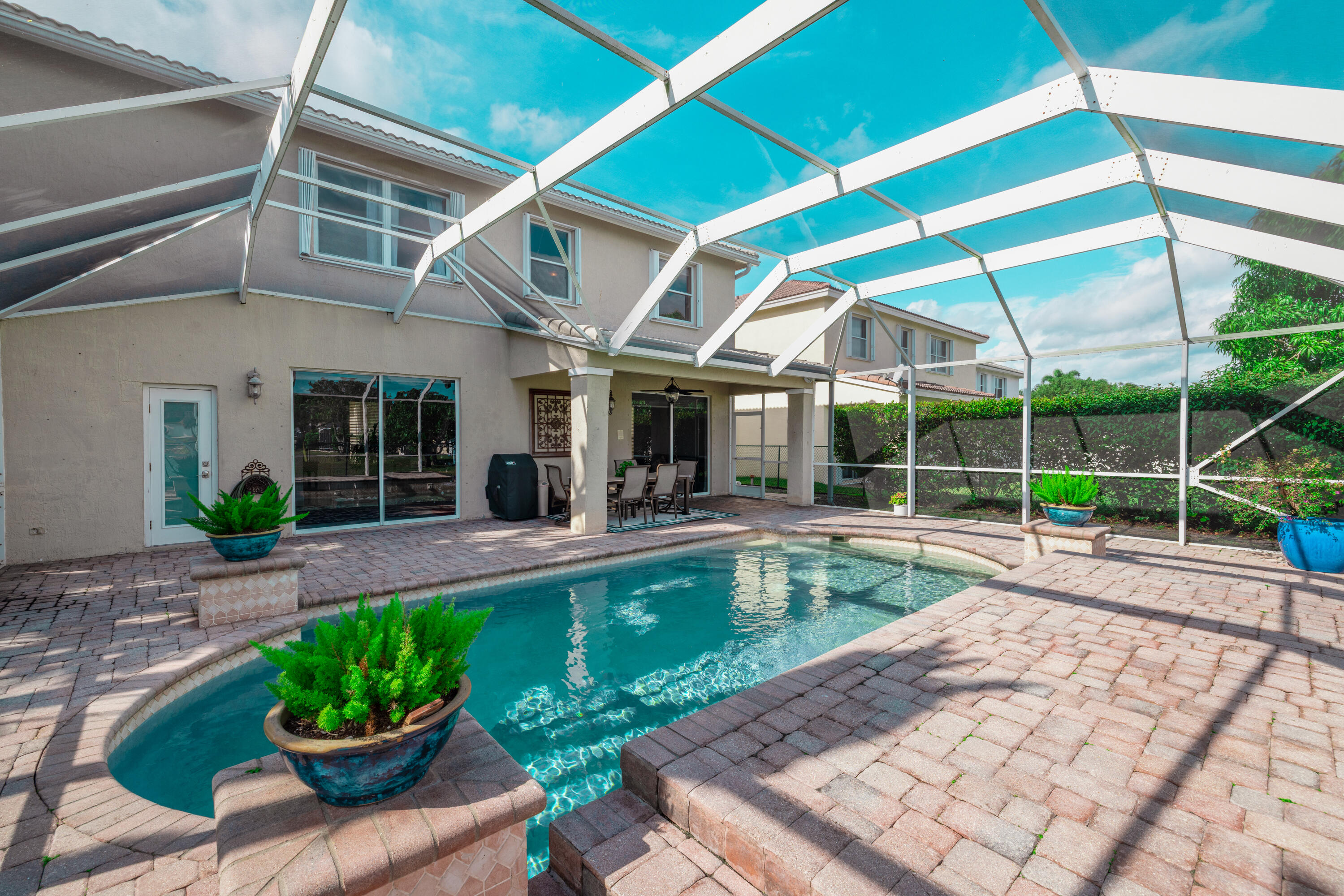 6575 Spring Meadow Drive Greenacres, FL 33413 - Photo 41 of 54 a view of a house with a yard patio and swimming pool