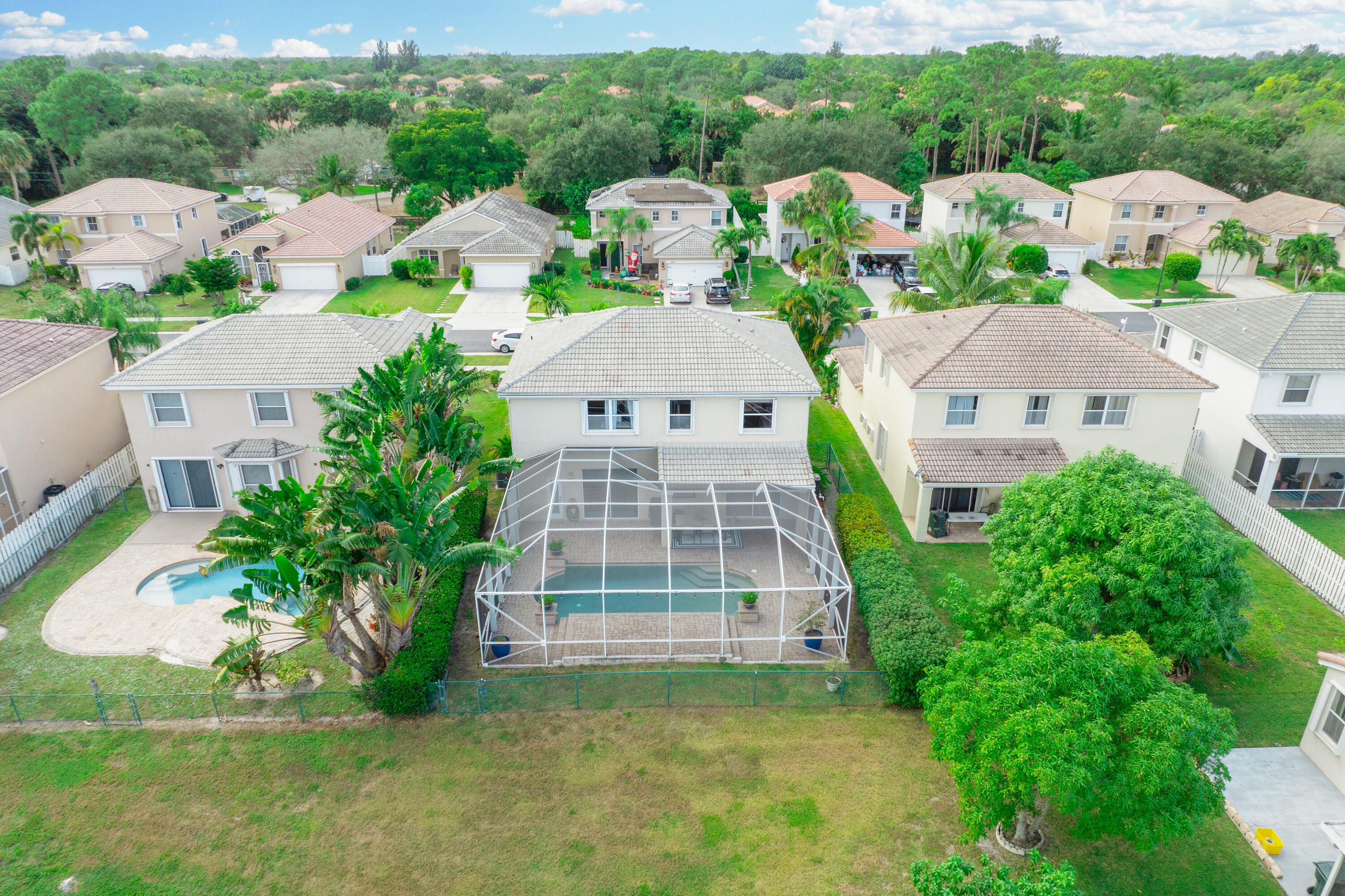 6575 Spring Meadow Drive Greenacres, FL 33413 - Photo 45 of 54 an aerial view of multiple houses with a yard