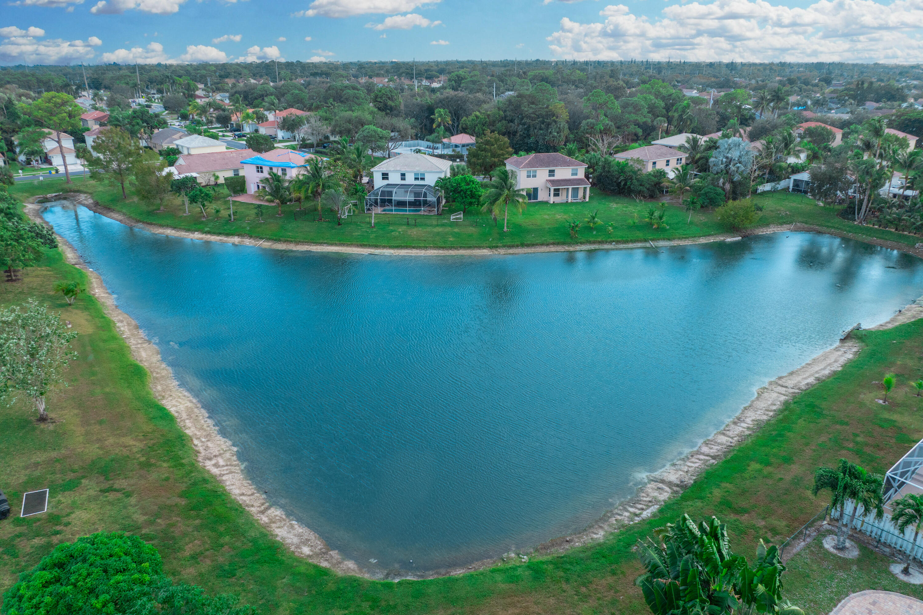 6575 Spring Meadow Drive Greenacres, FL 33413 - Photo 47 of 54 a view of a lake with a mountain in the background