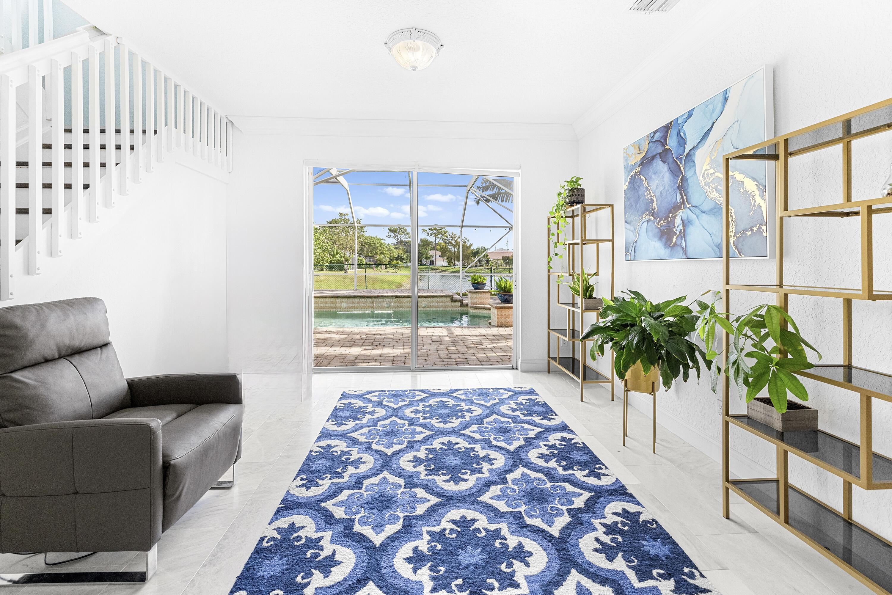 6575 Spring Meadow Drive Greenacres, FL 33413 - Photo 5 of 54 a living room with furniture and a potted plant