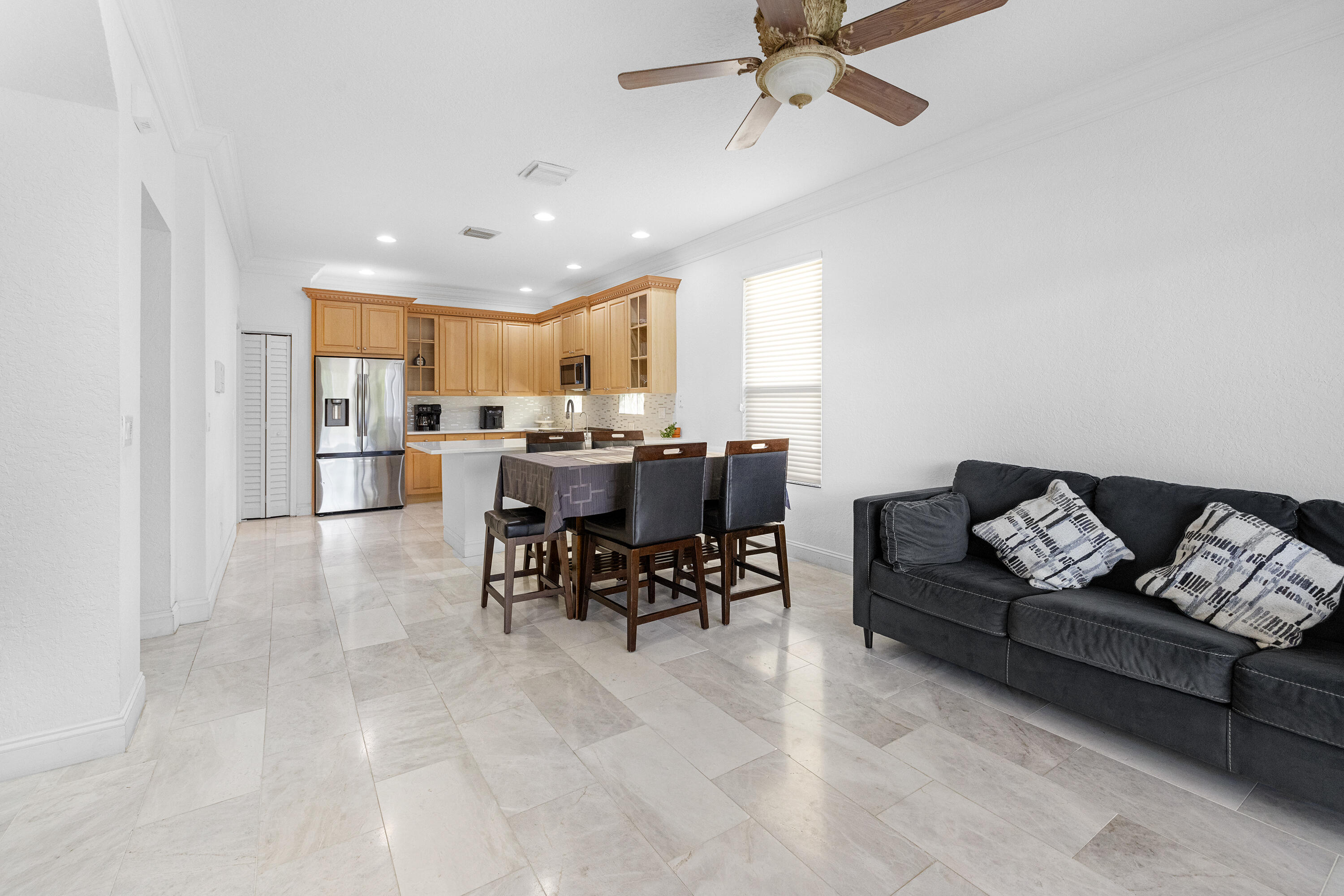 6575 Spring Meadow Drive Greenacres, FL 33413 - Photo 10 of 54 a living room with furniture and kitchen view