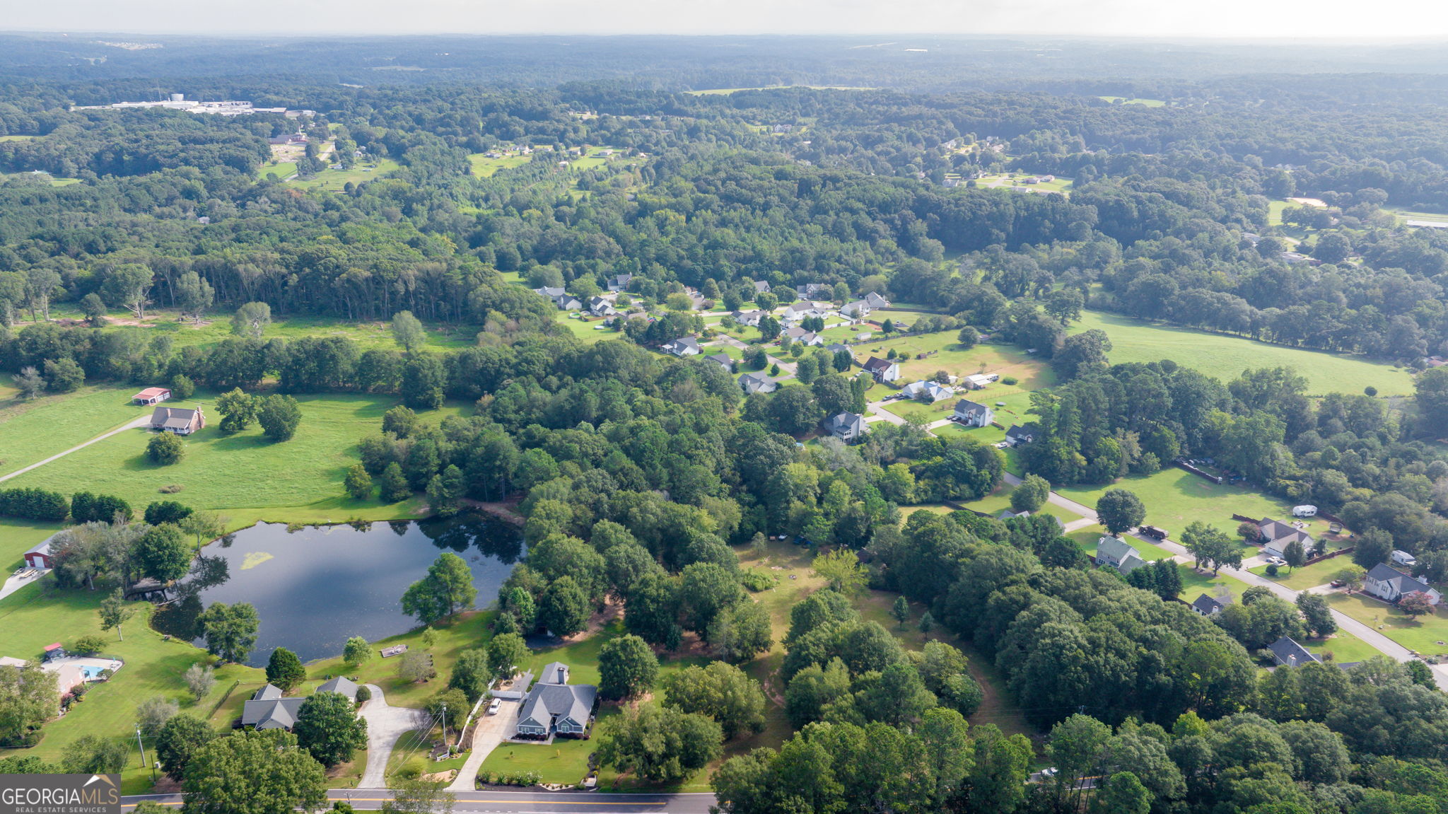 0 McElhannon Road Southeast Bethlehem, GA 30620 - Photo 12 of 23 an aerial view of a houses with a yard and lake view