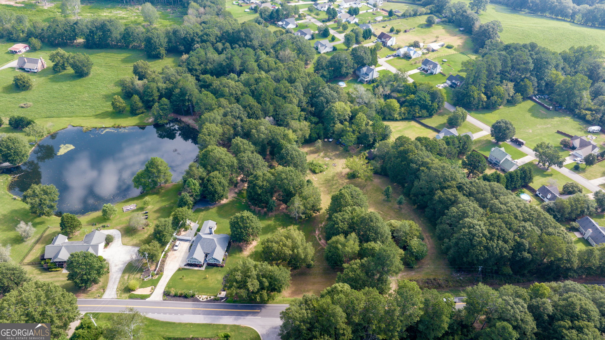 0 McElhannon Road Southeast Bethlehem, GA 30620 - Photo 10 of 23 an aerial view of a residential houses with outdoor space and trees all around