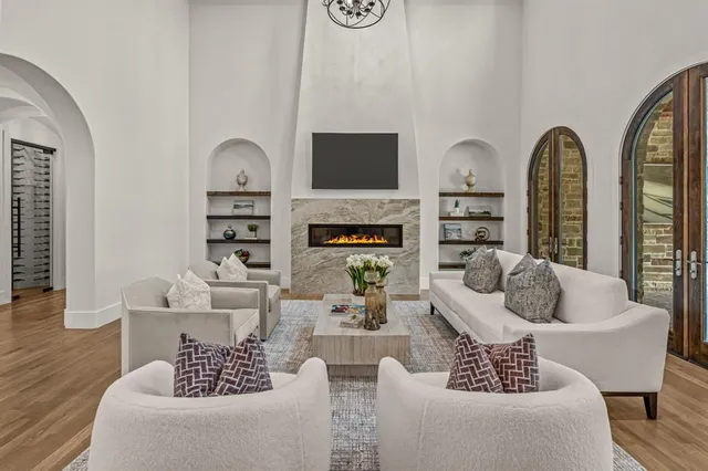 a living room with furniture fireplace and flat screen tv
