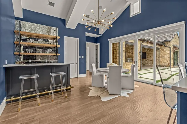 a view of a dining room with furniture and a chandelier