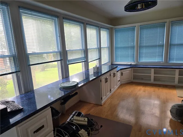 a view of a workspace with furniture and window