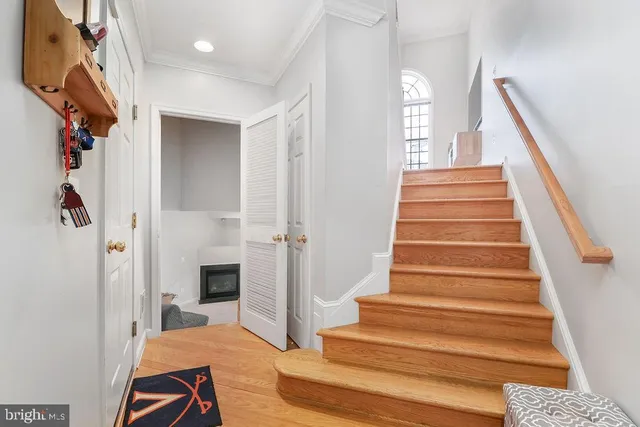 a view of entryway and hall with wooden floor