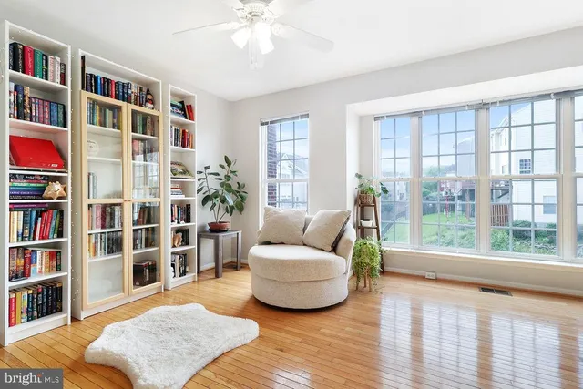 a living room with furniture and a book shelf