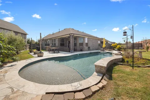 a view of a swimming pool with a patio