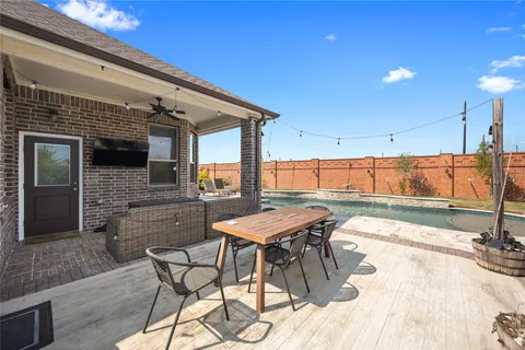 a view of a patio with a table and chairs