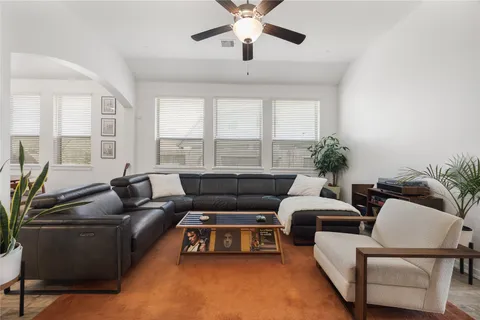 a living room with furniture and a large window
