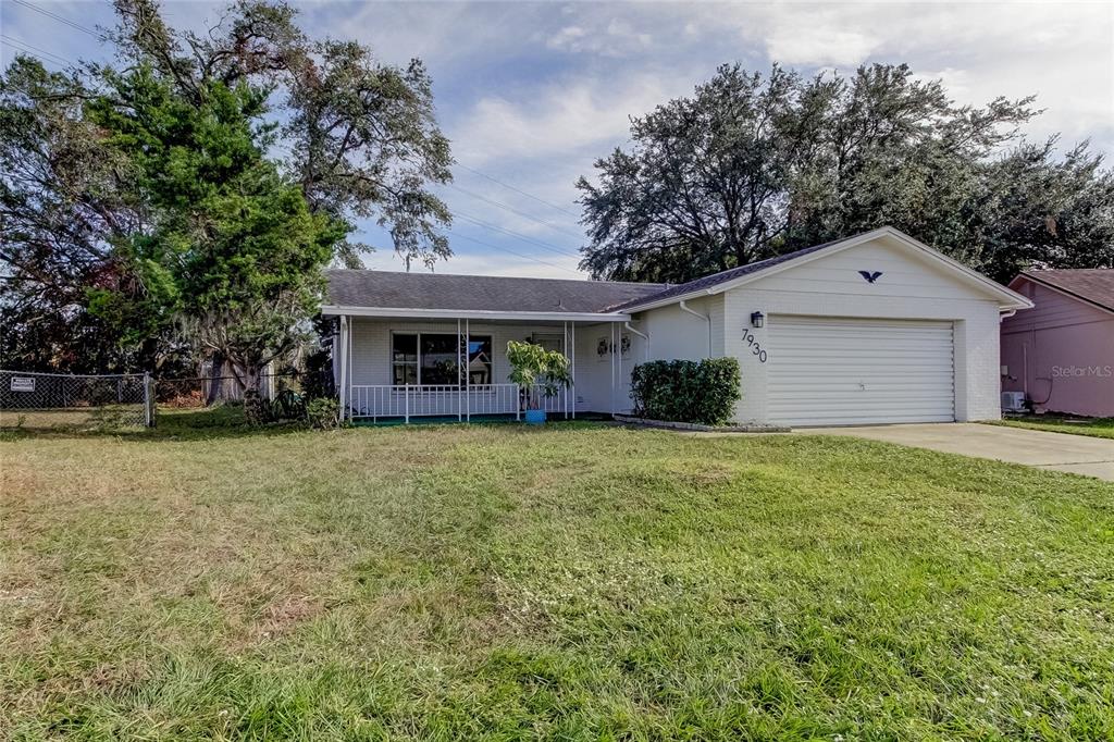 7930 Aden Loop New Port Richey, FL 34655 - Photo 1 of 1 a front view of a house with a garden