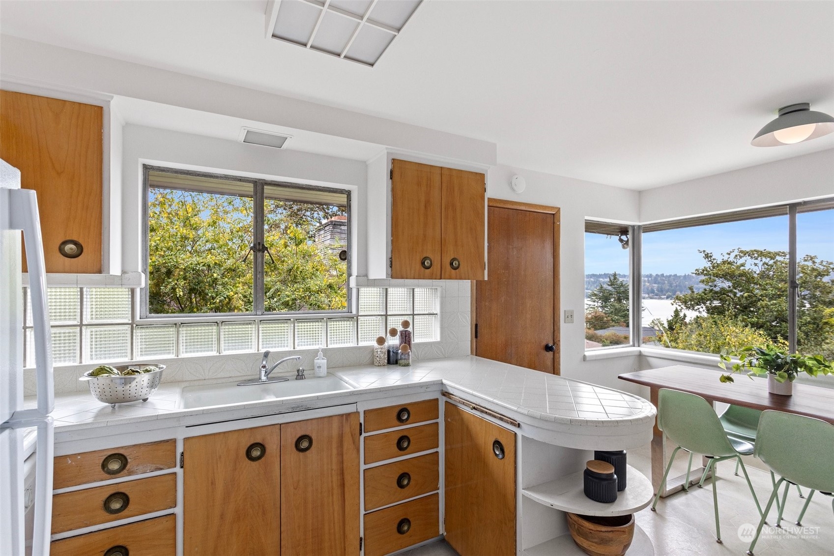 5709 South Upland Road Seattle, WA 98118 - Photo 11 of 37 a kitchen with a stove a sink and a refrigerator