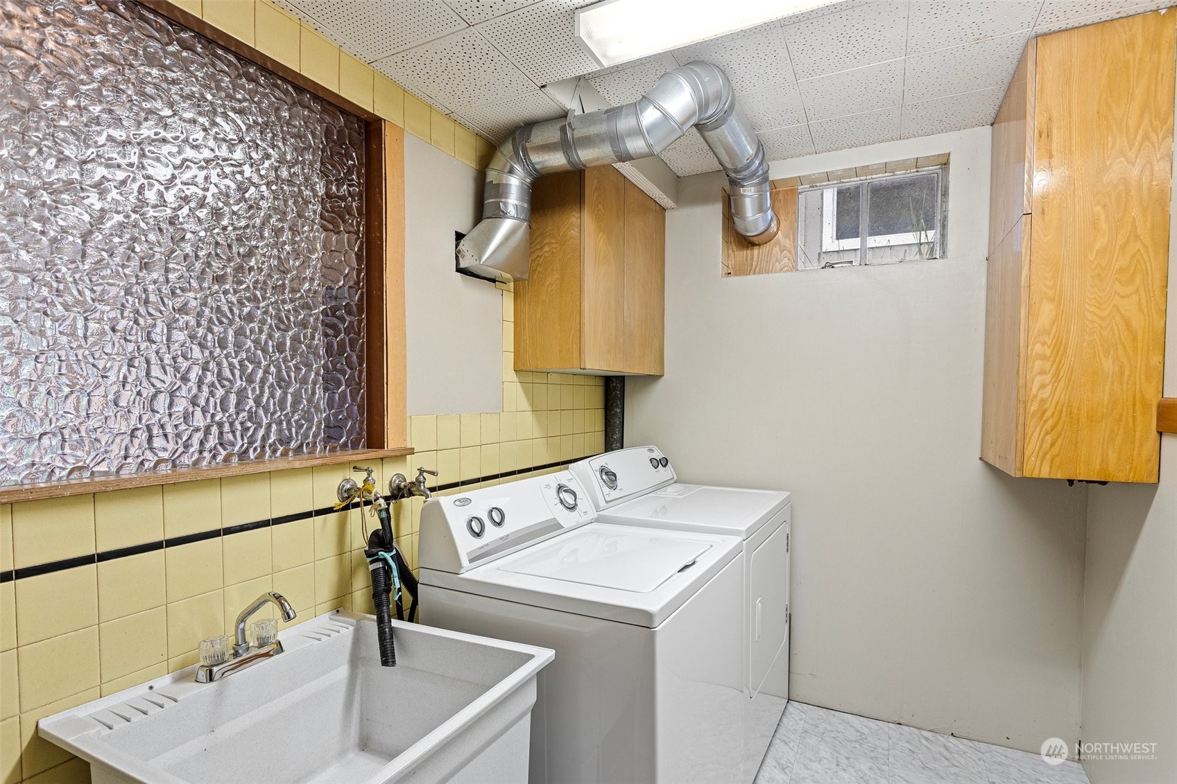 5709 South Upland Road Seattle, WA 98118 - Photo 26 of 37 a bathroom with a sink and a mirror