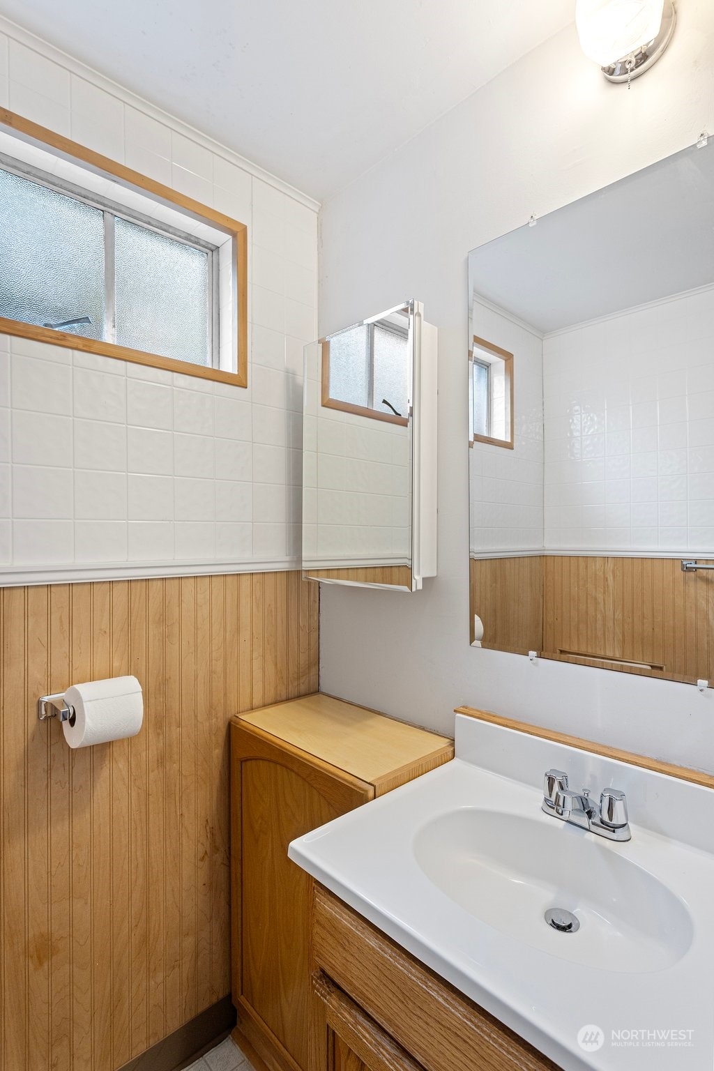 5709 South Upland Road Seattle, WA 98118 - Photo 27 of 37 a bathroom with a sink and a mirror
