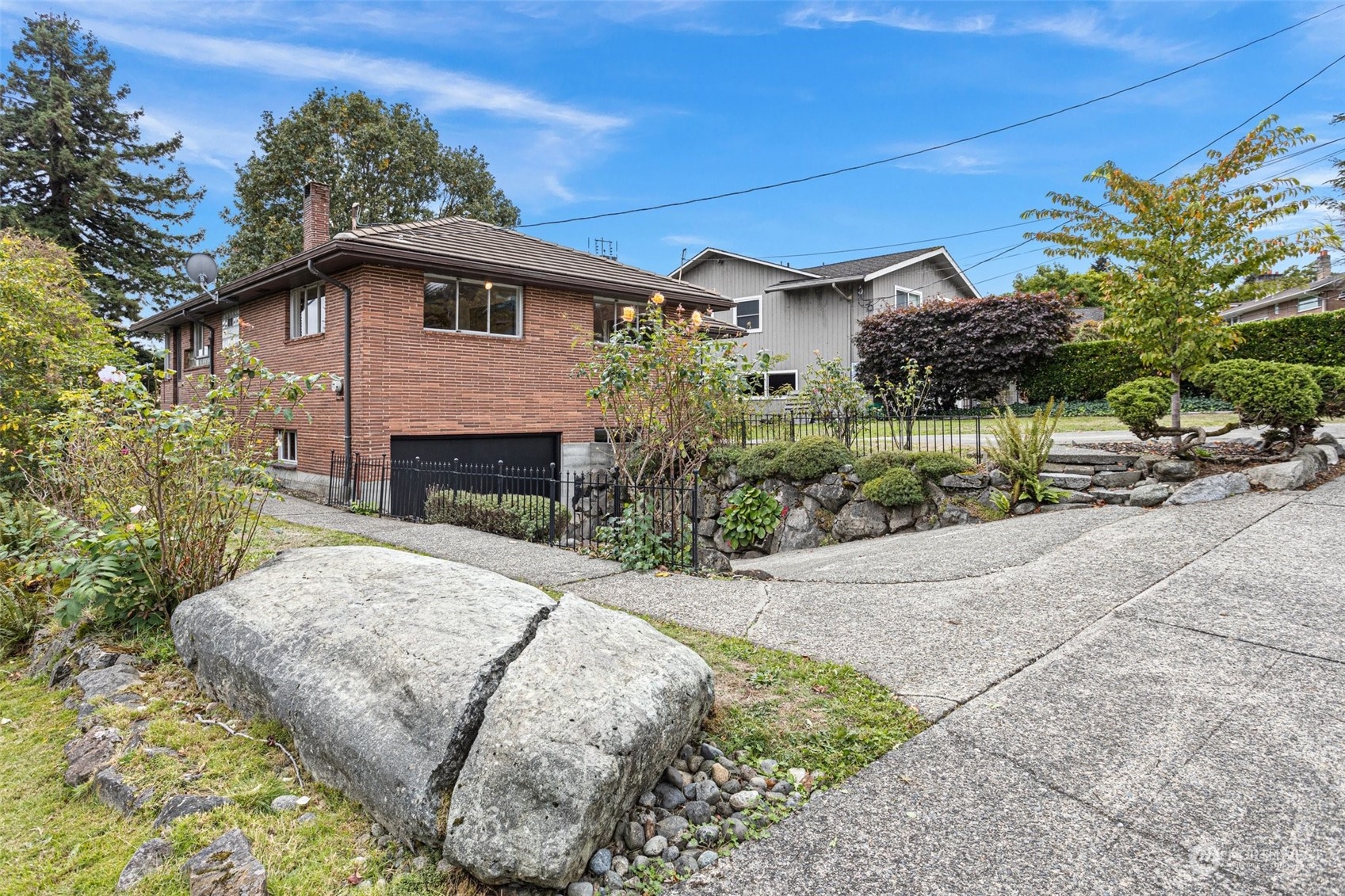 5709 South Upland Road Seattle, WA 98118 - Photo 33 of 37 a backyard of a house with plants and outdoor seating