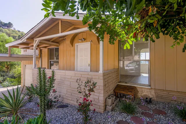 a front view of a house with garden