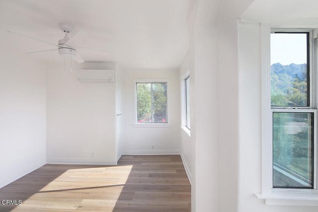 a view of an entryway with wooden floor and windows