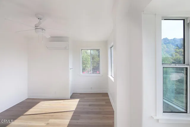 a view of an entryway with wooden floor and windows