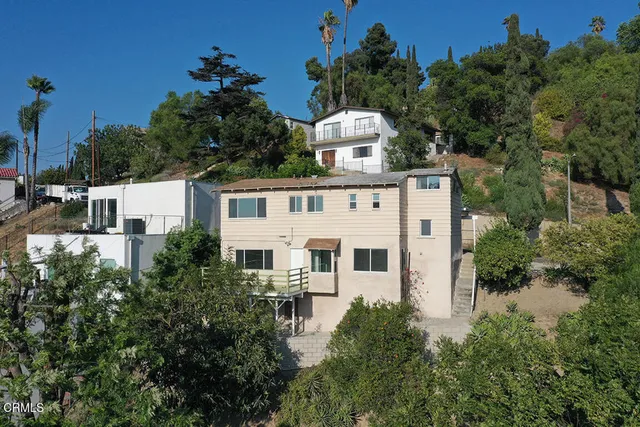 an aerial view of a house with a yard