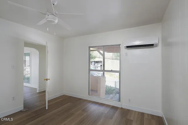 wooden floor in an empty room with a window