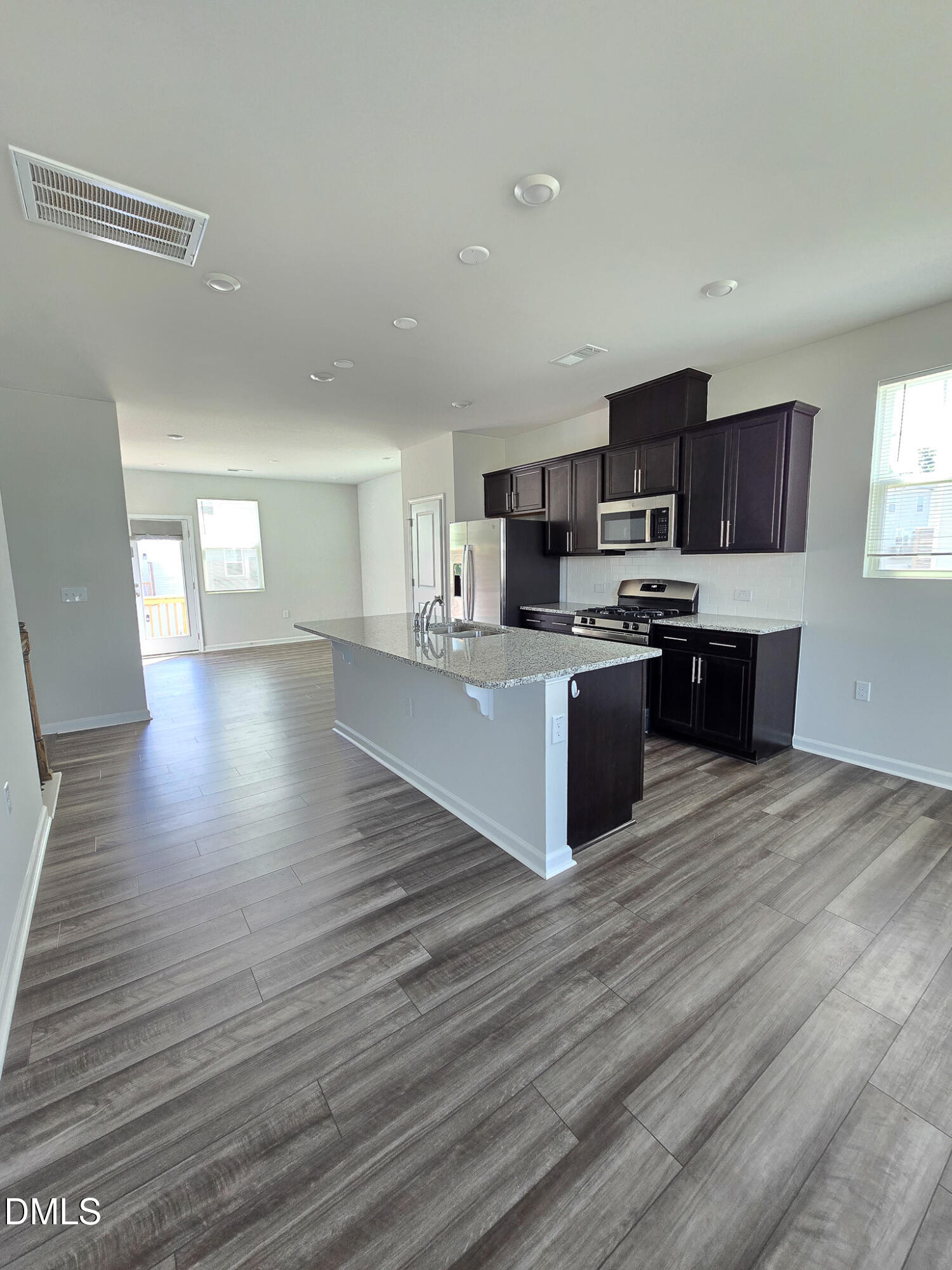 2431 Kasota Lane Raleigh, NC 27610 - Photo 16 of 46 a large kitchen with cabinets and wooden floor