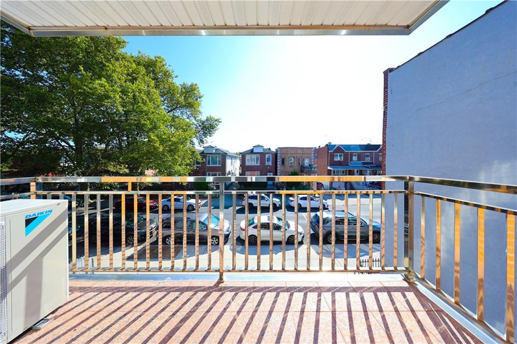 1725 68th Street, Unit 3F Brooklyn, NY 11204 - Photo 18 of 19 a view of a balcony with wooden floor and fence