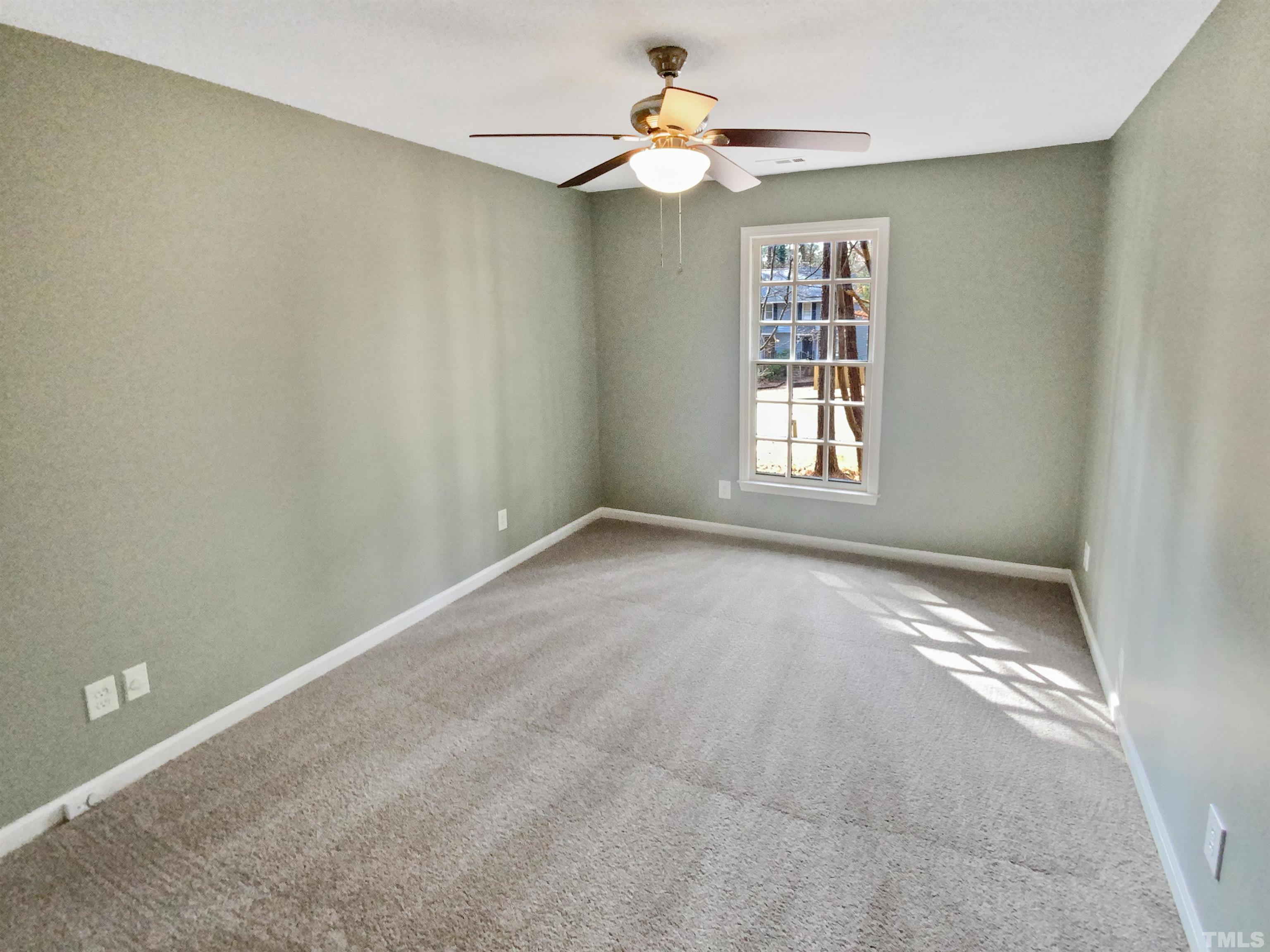 6920 Glendower Road Raleigh, NC 27613 - Photo 9 of 32 an empty room with windows and fan