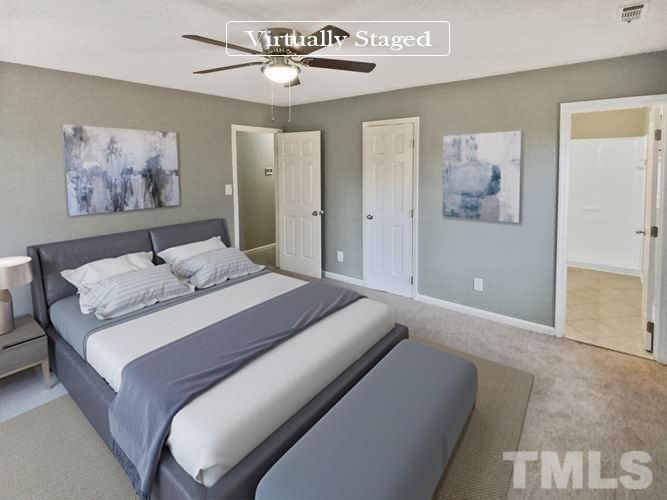 6920 Glendower Road Raleigh, NC 27613 - Photo 10 of 32 a bedroom with a large bed and a chandelier