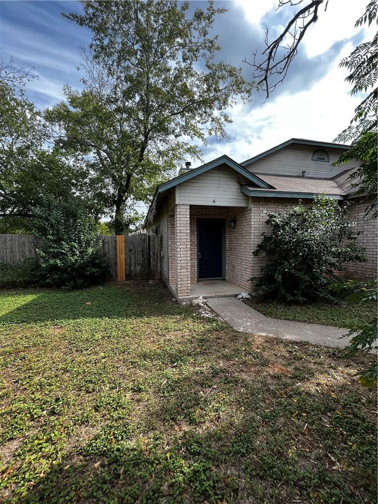 2601 Alcott Lane, Unit A Austin, TX 78748 - Photo 1 of 1 a view of a wooden house with a yard and large tree