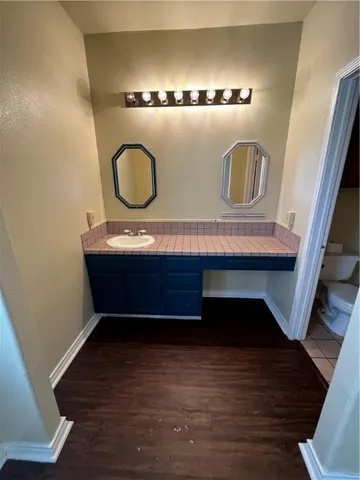 a room with a table chairs and wooden floor