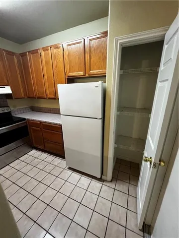 a kitchen with a refrigerator and a stove