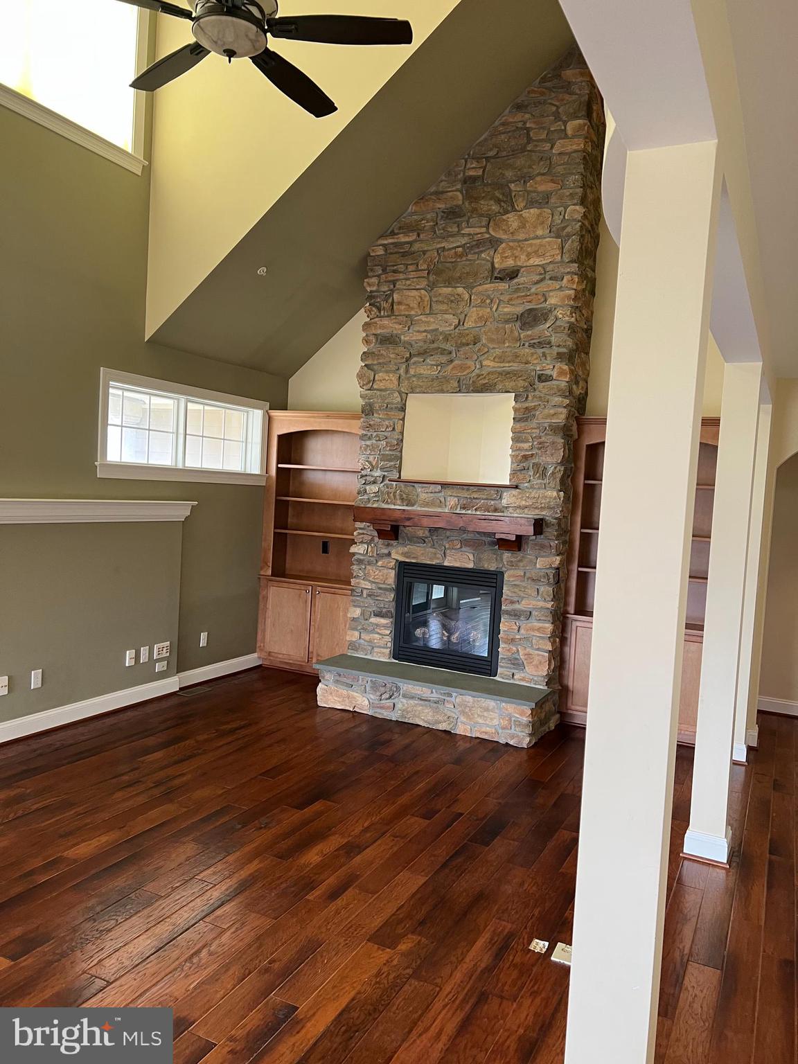 3913 Cap Stine Road Frederick, MD 21703 - Photo 5 of 19 a view of an empty room with wooden floor fireplace and a window