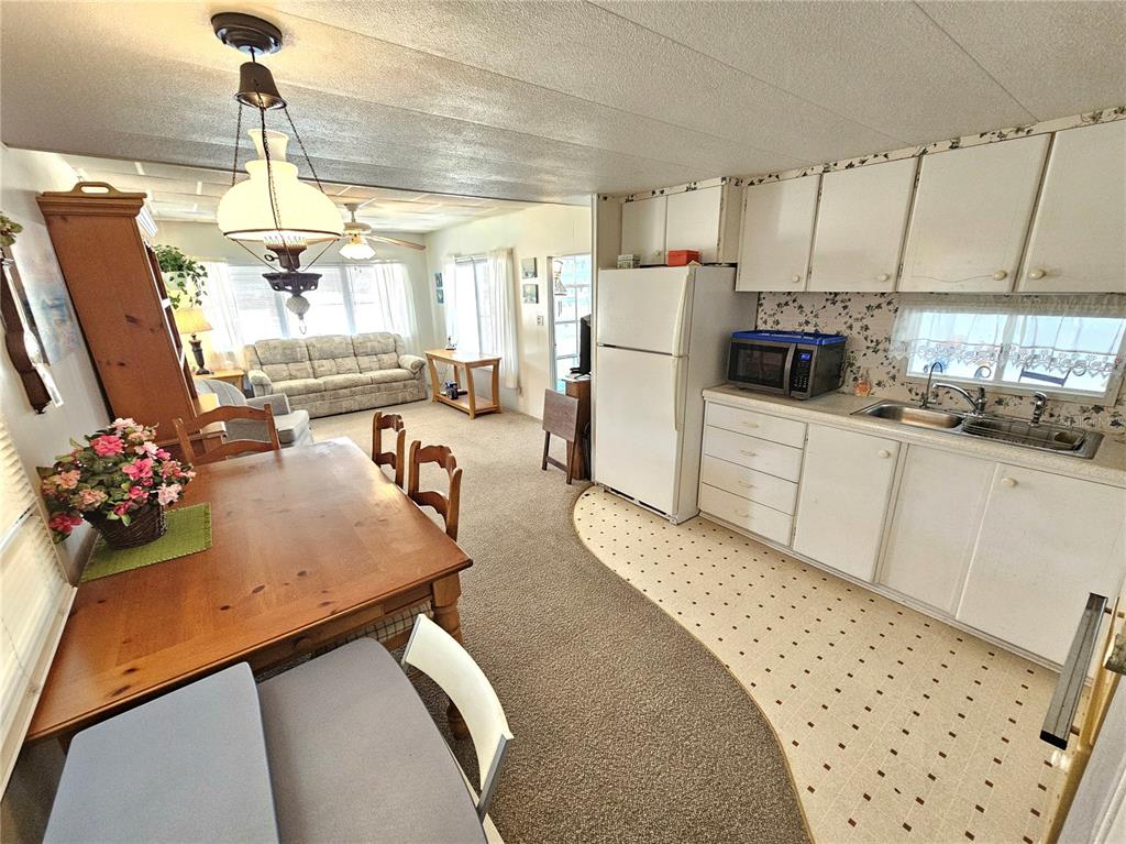 110 Roma Road Venice, FL 34285 - Photo 4 of 45 a kitchen with sink refrigerator and window
