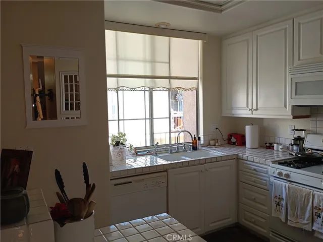 a view of a hallway with furniture and a window