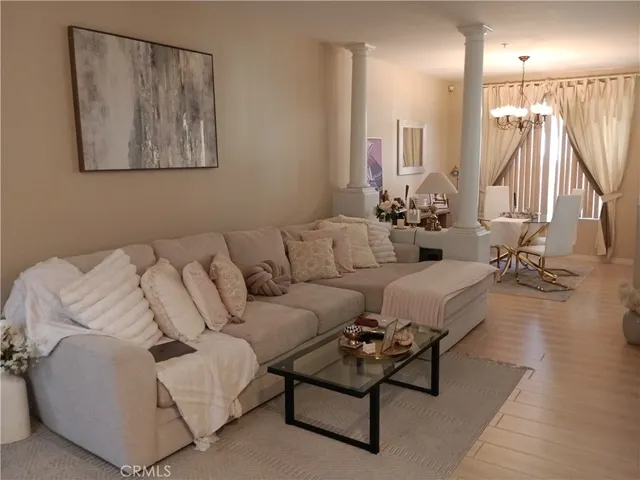 a living room with furniture and a large mirror