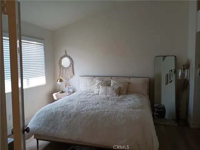 a large bed sitting in a bedroom next to a lamp
