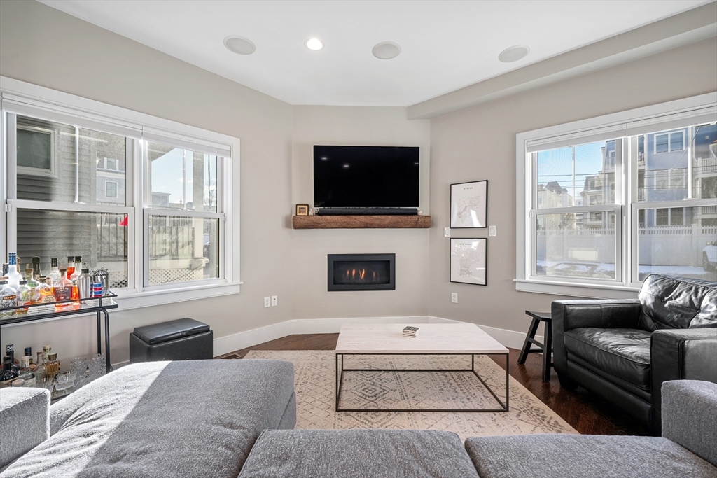 861 East 2nd Street, Unit 1 Boston, MA 02127 - Photo 11 of 30 a living room with furniture a flat screen tv and a fireplace
