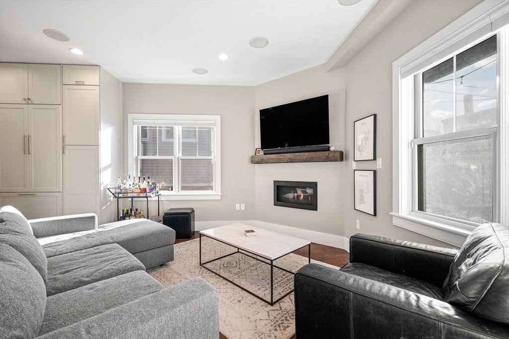 861 East 2nd Street, Unit 1 Boston, MA 02127 - Photo 9 of 30 a living room with furniture a flat screen tv and a fireplace
