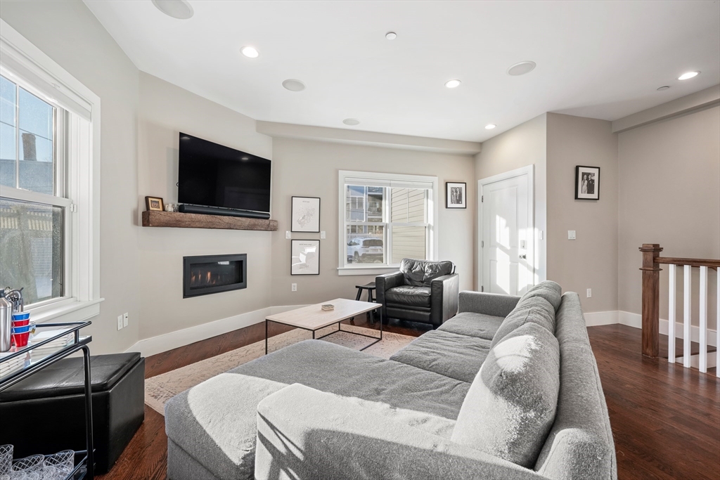 861 East 2nd Street, Unit 1 Boston, MA 02127 - Photo 10 of 30 a living room with furniture a flat screen tv and a fireplace