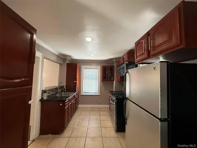 a kitchen with stainless steel appliances granite countertop a refrigerator and a stove top oven