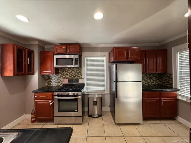 a kitchen with a refrigerator and a stove