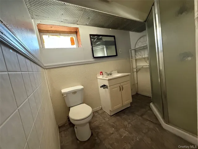 a white toilet sitting next to a bathroom sink and vanity
