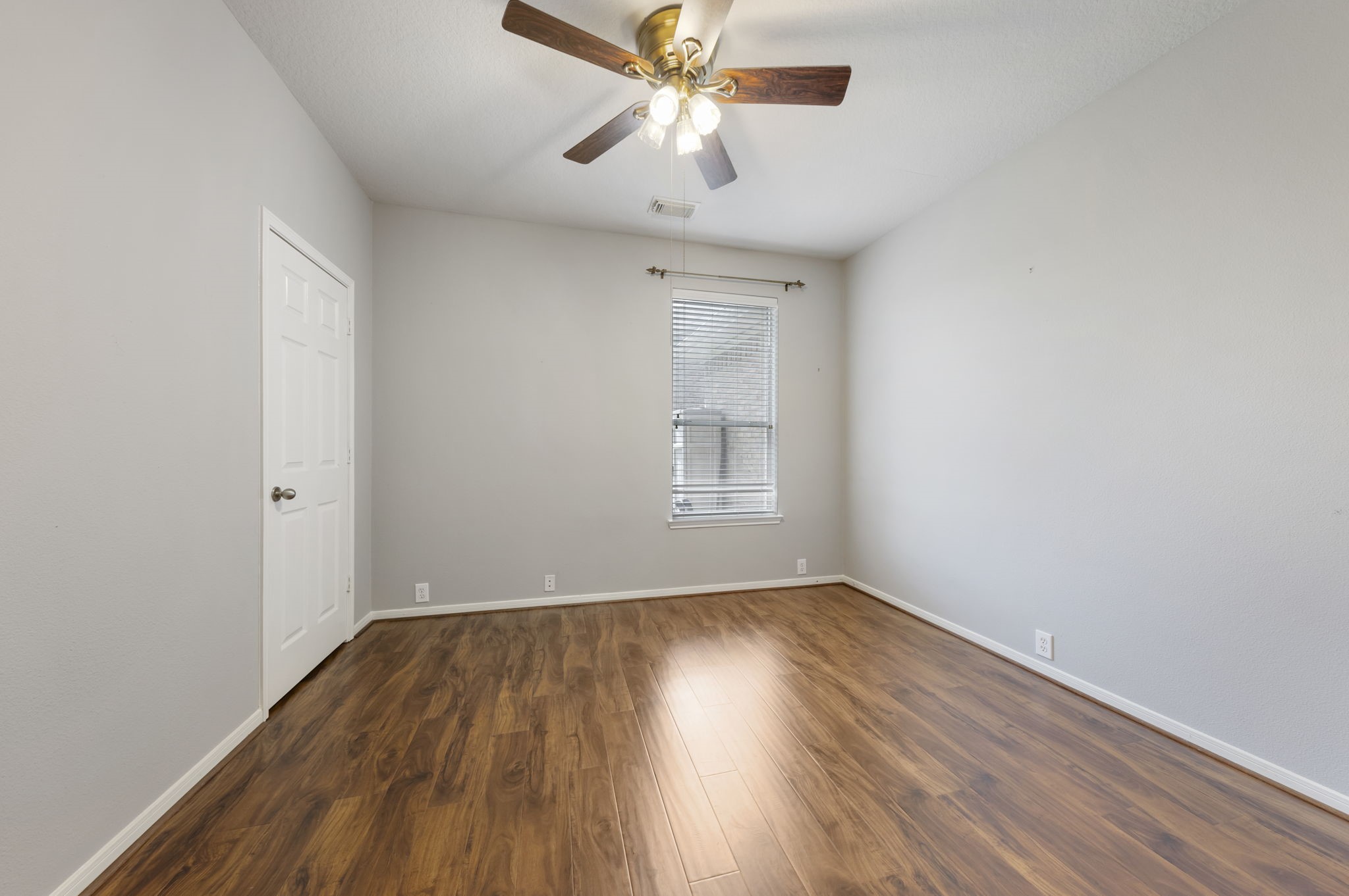 2907 Stemwood Drive Spring, TX 77388 - Photo 17 of 33 First-floor guest bedroom with wood-look flooring, natural light, and a versatile layout ideal for guests, a home office, or additional living space.