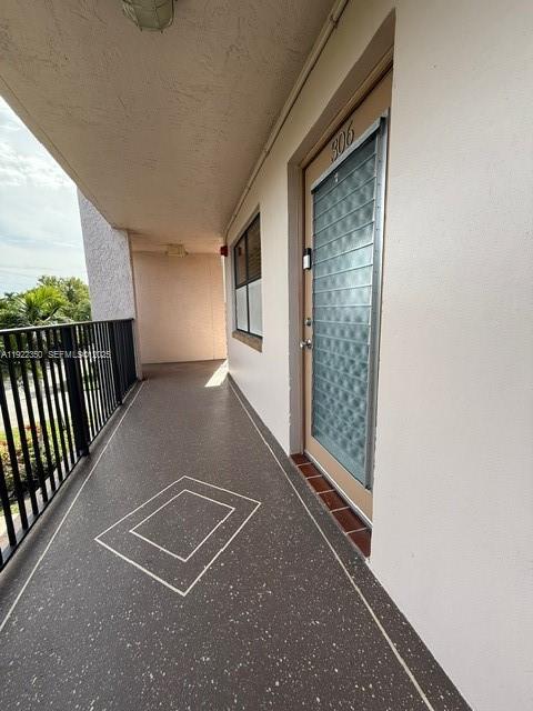 a view of a porch with wooden floor and fence